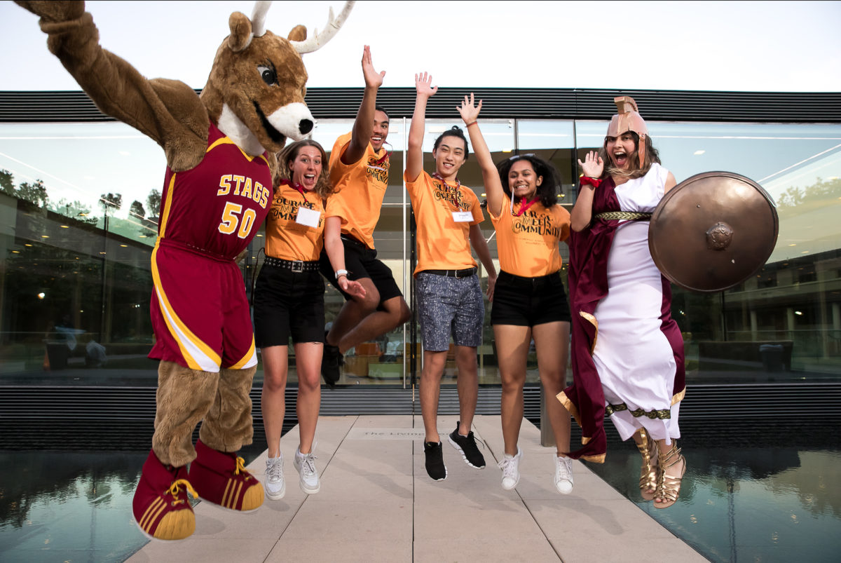 CMS Athletics students and mascot jumping in the air and cheering