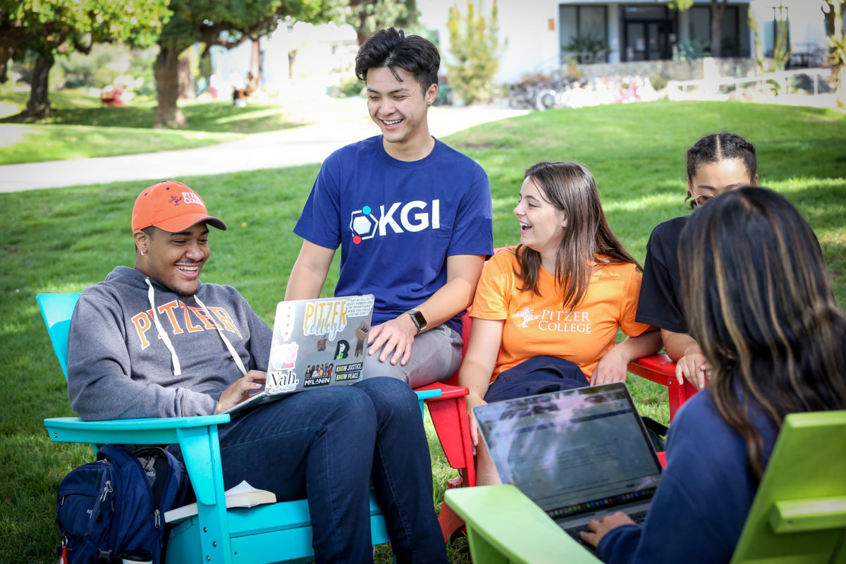 Students sitting outdoors talking.