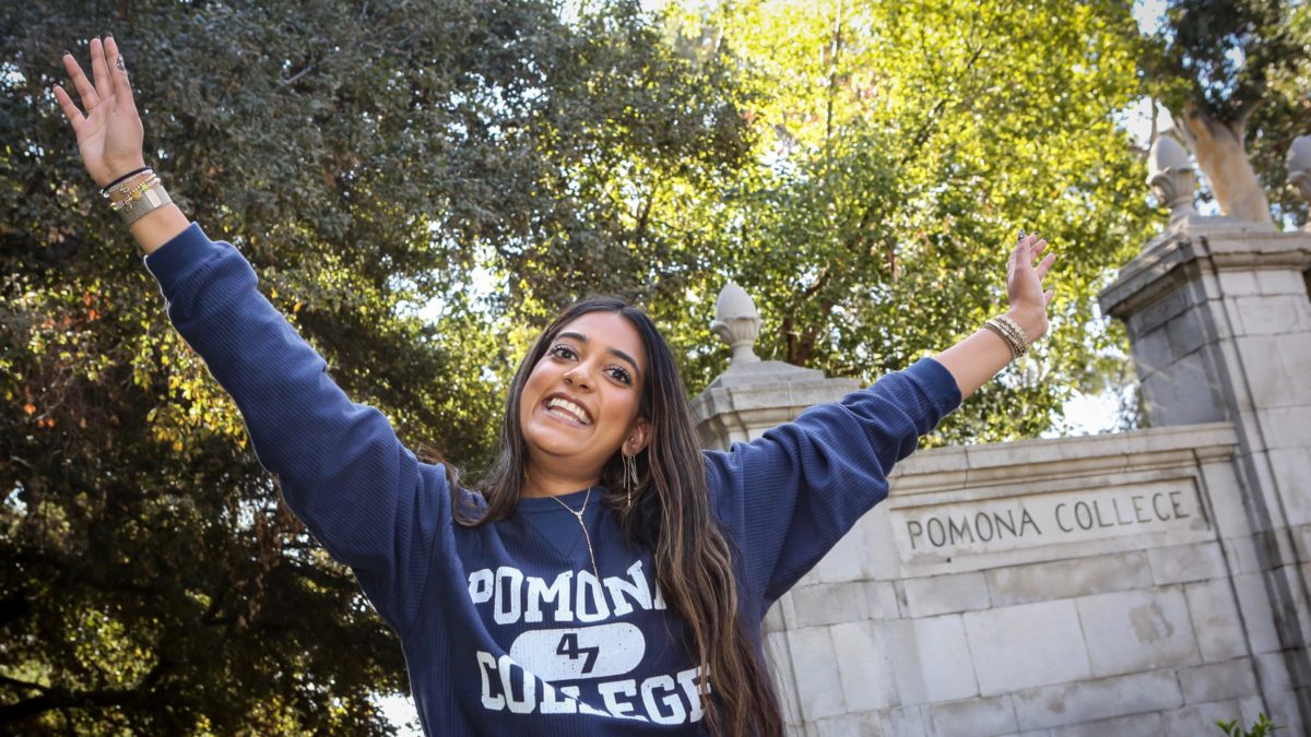 Pomona student cheering outside Pomona College gates
