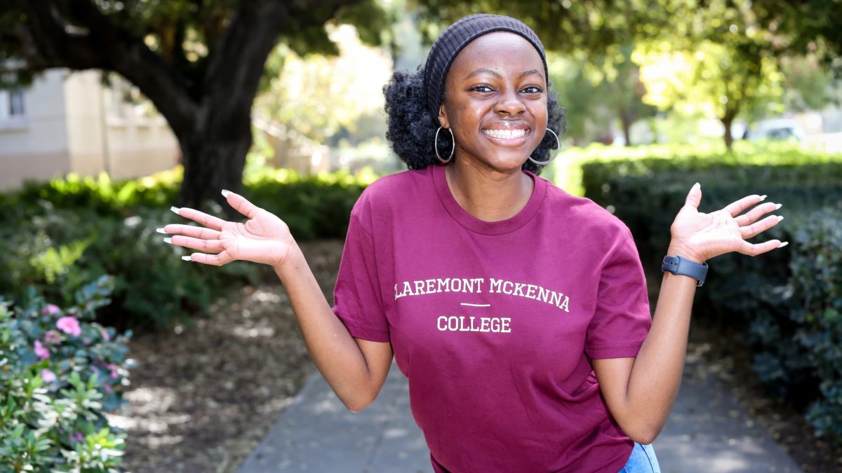 Claremont McKenna student smiling with arms out.