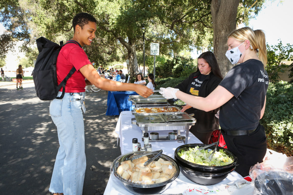 student served food from outdoor food vendor